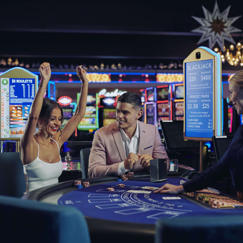 A couple sitting at a Casino table game